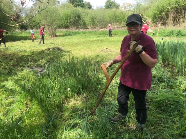 lady scything long grass 