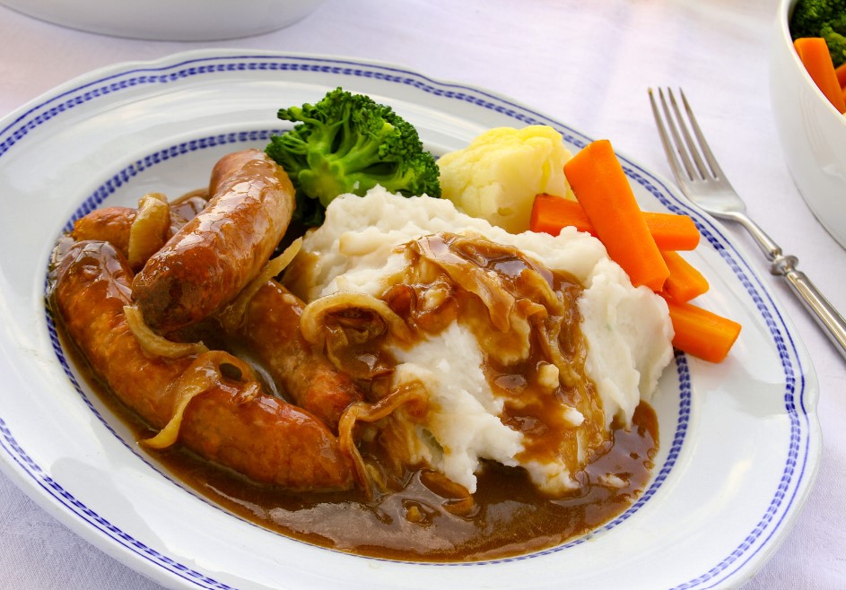 sausages and mashed served on a plate with carrots ad broccoli