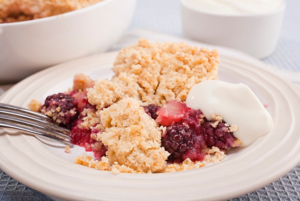 blackberry and apple crumble served with a dollop of cream