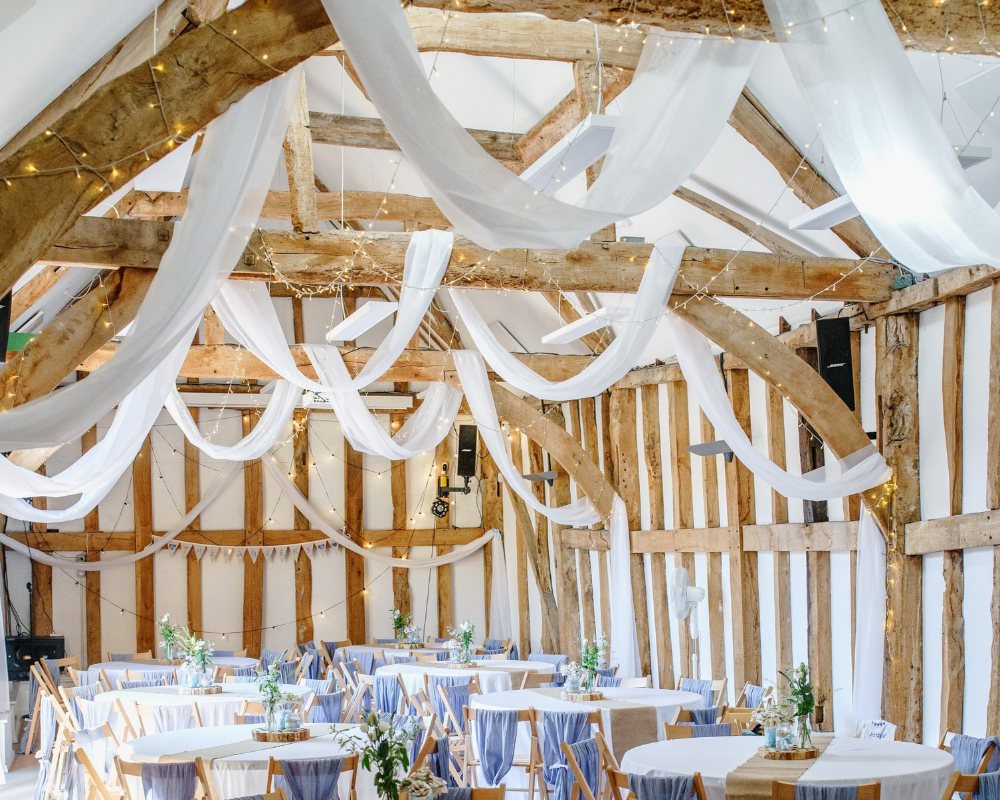 Fison Barn beams decorated with drapes for a wedding