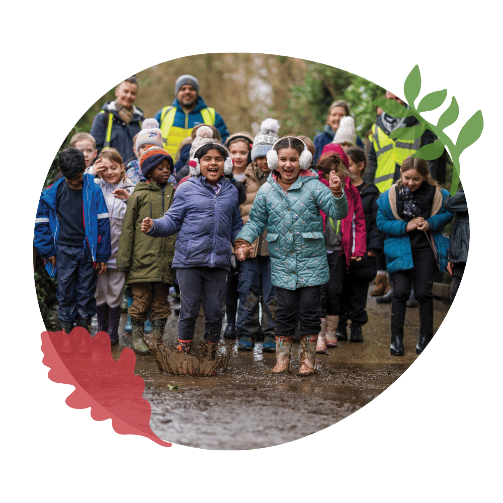 School children jumping in a puddle