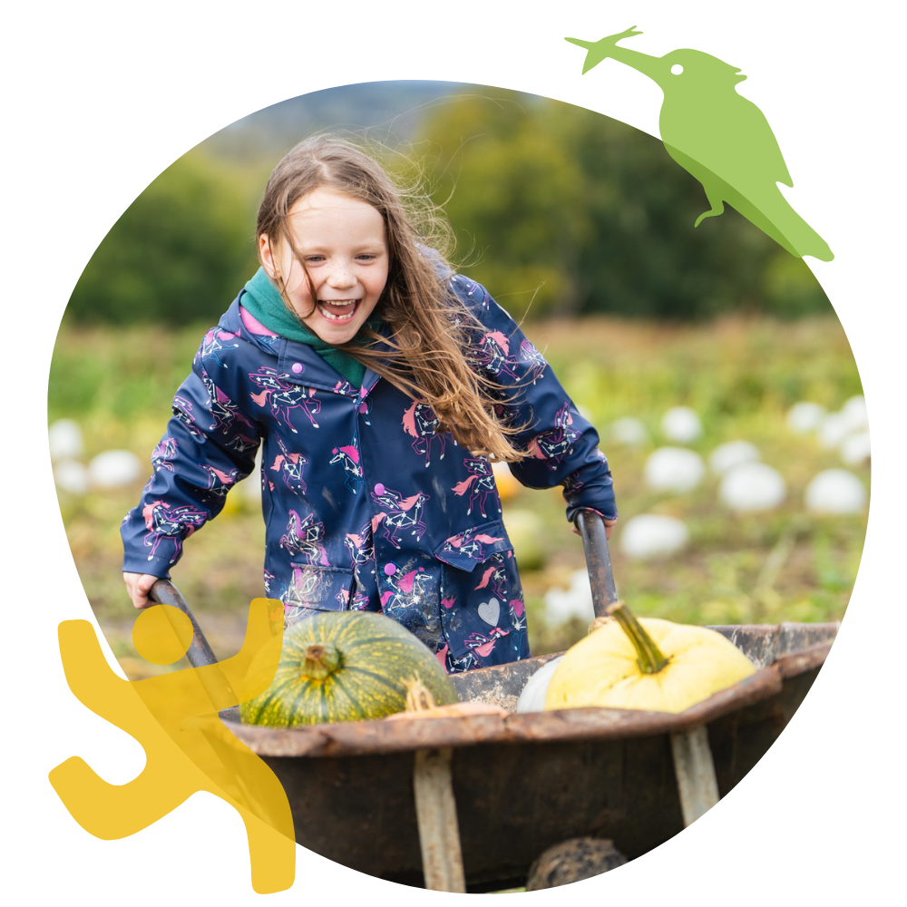 Girl laughing and running with a wheelbarrow. Credit: Chloe Lee